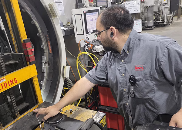 Anthony Tapia performing a Temperature Uniformity Survey on a customer's vacuum furnace